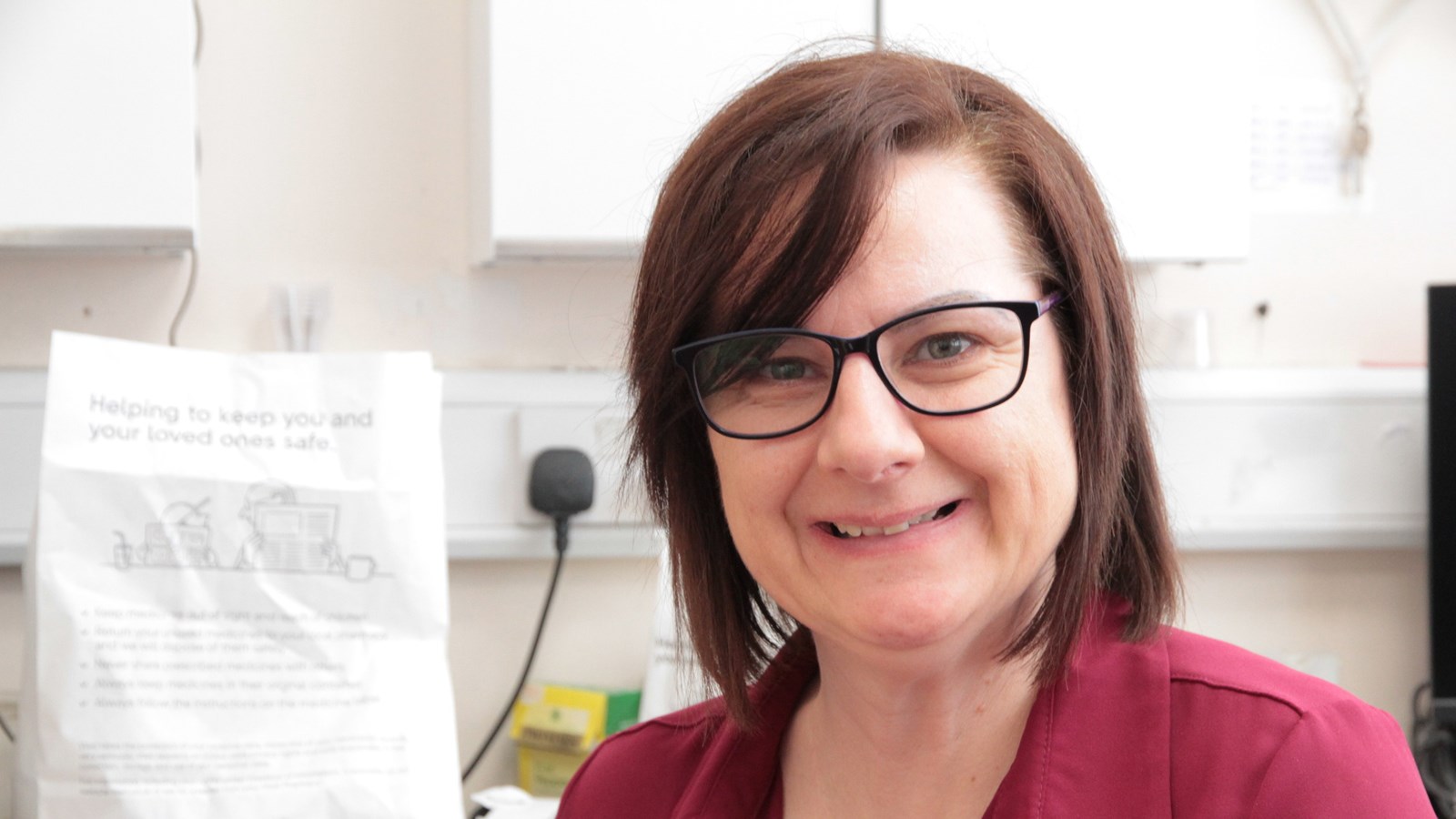 A lady support worker smiling at the camera.