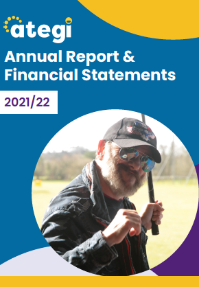 Front cover to the Ategi annual report. It has a man smiling at the camera.