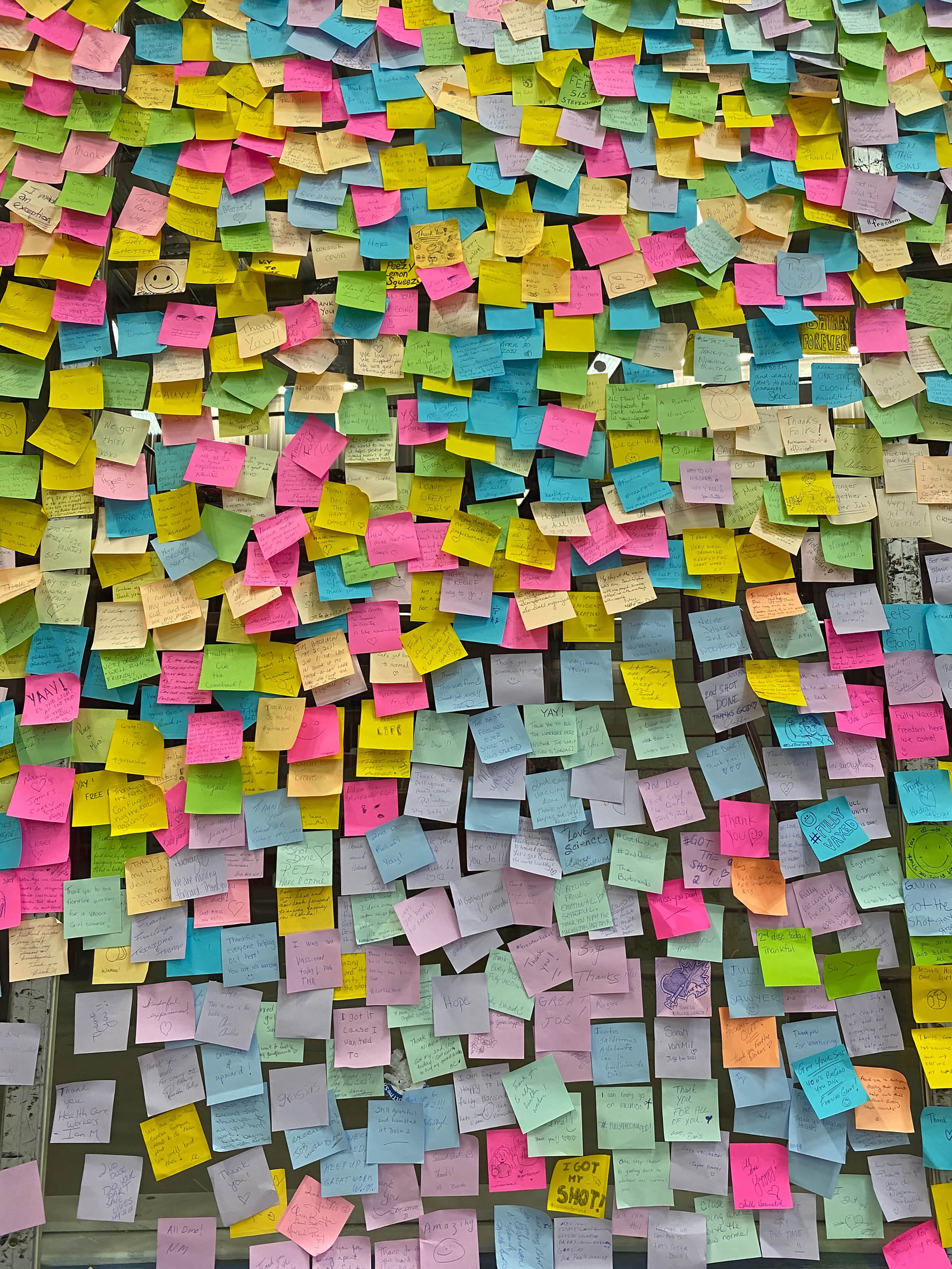  A wall of multicoloured post it notes. 