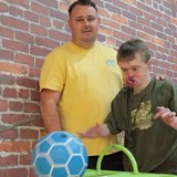 Richie, a young man with learning disabilities who is being supported to do some bowling with his support worker.