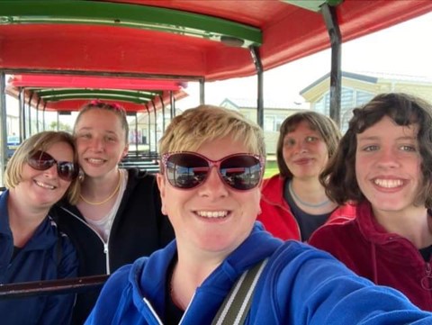 A group of women taking a selfie on a train