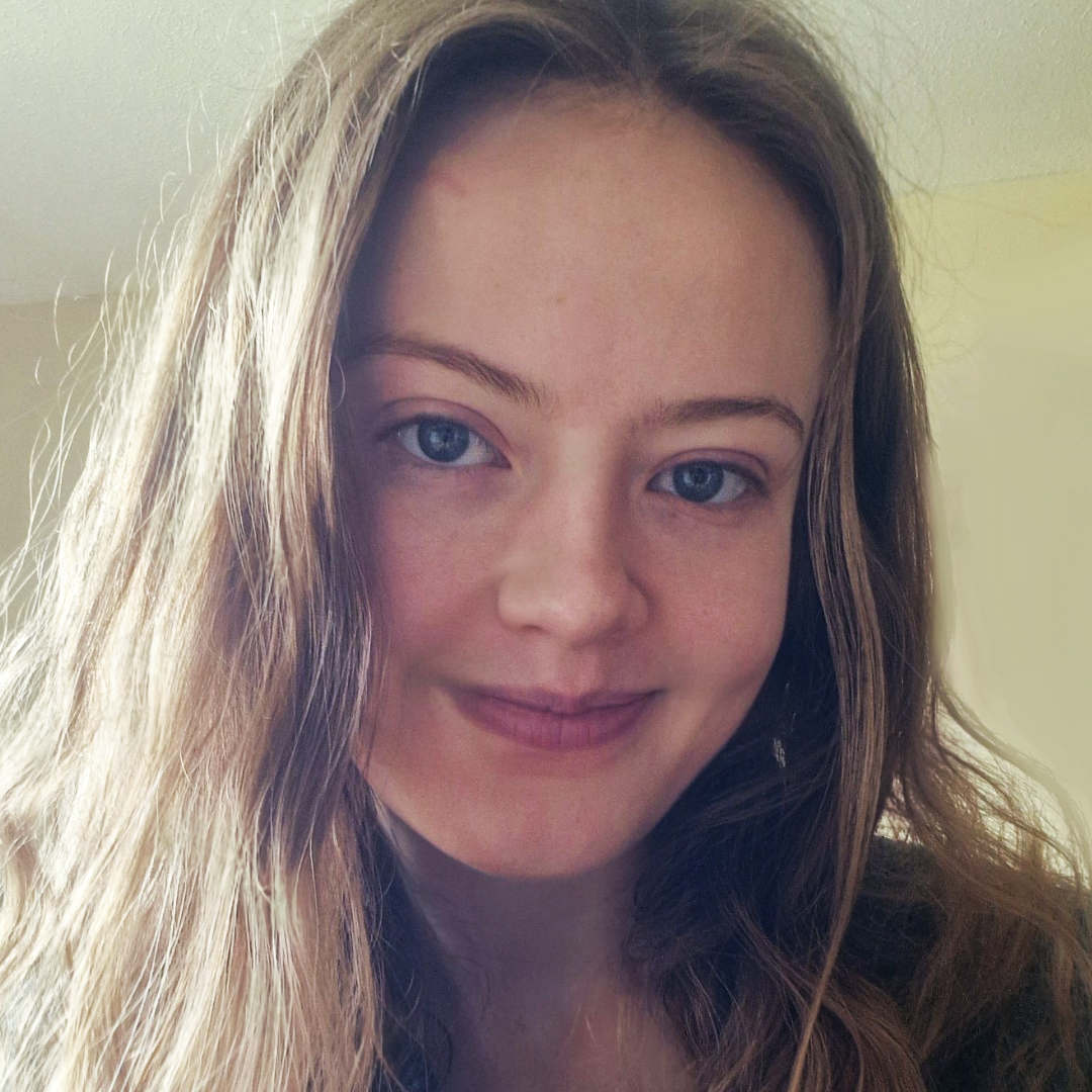 A picture of Abi Walker-Spiers looking at the viewer