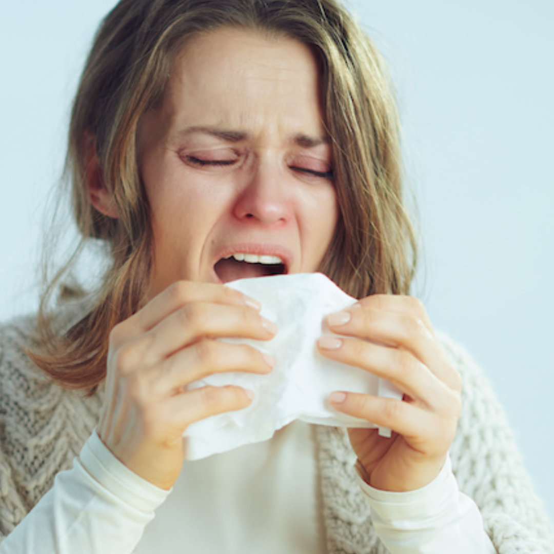 Picture of a woman sneezzing