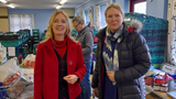 KAte and Karen smiling at the camera in a foodbank.