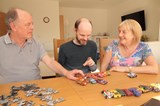 Martin and Liz supporting their son with learning disabilities play with his toy cars. 