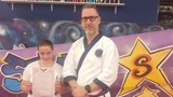 Alana being award a new belt in her martial arts 