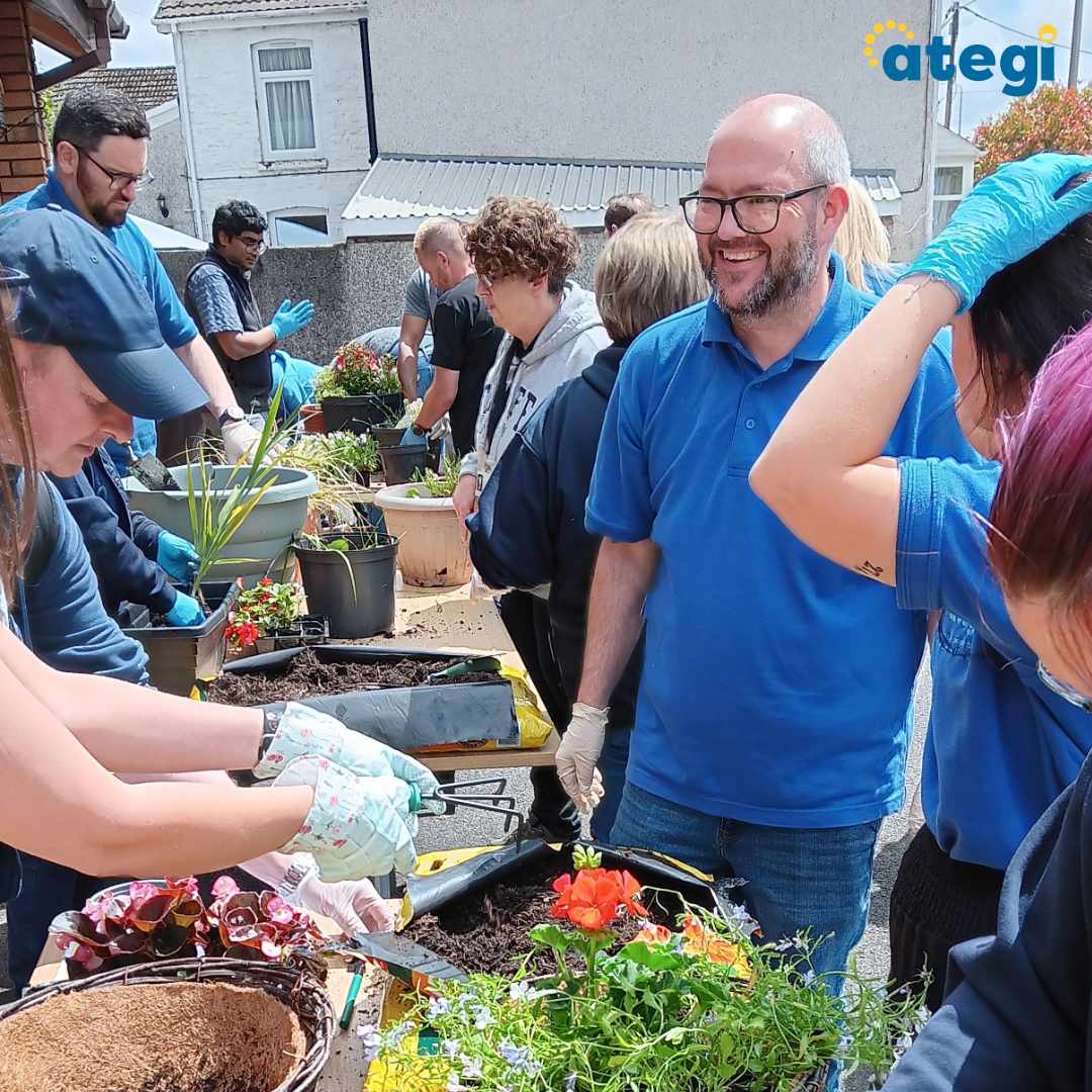 A photo of Ategi colleagues, volunteers and people we support having fun planting