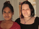 Two women standing together and smiling