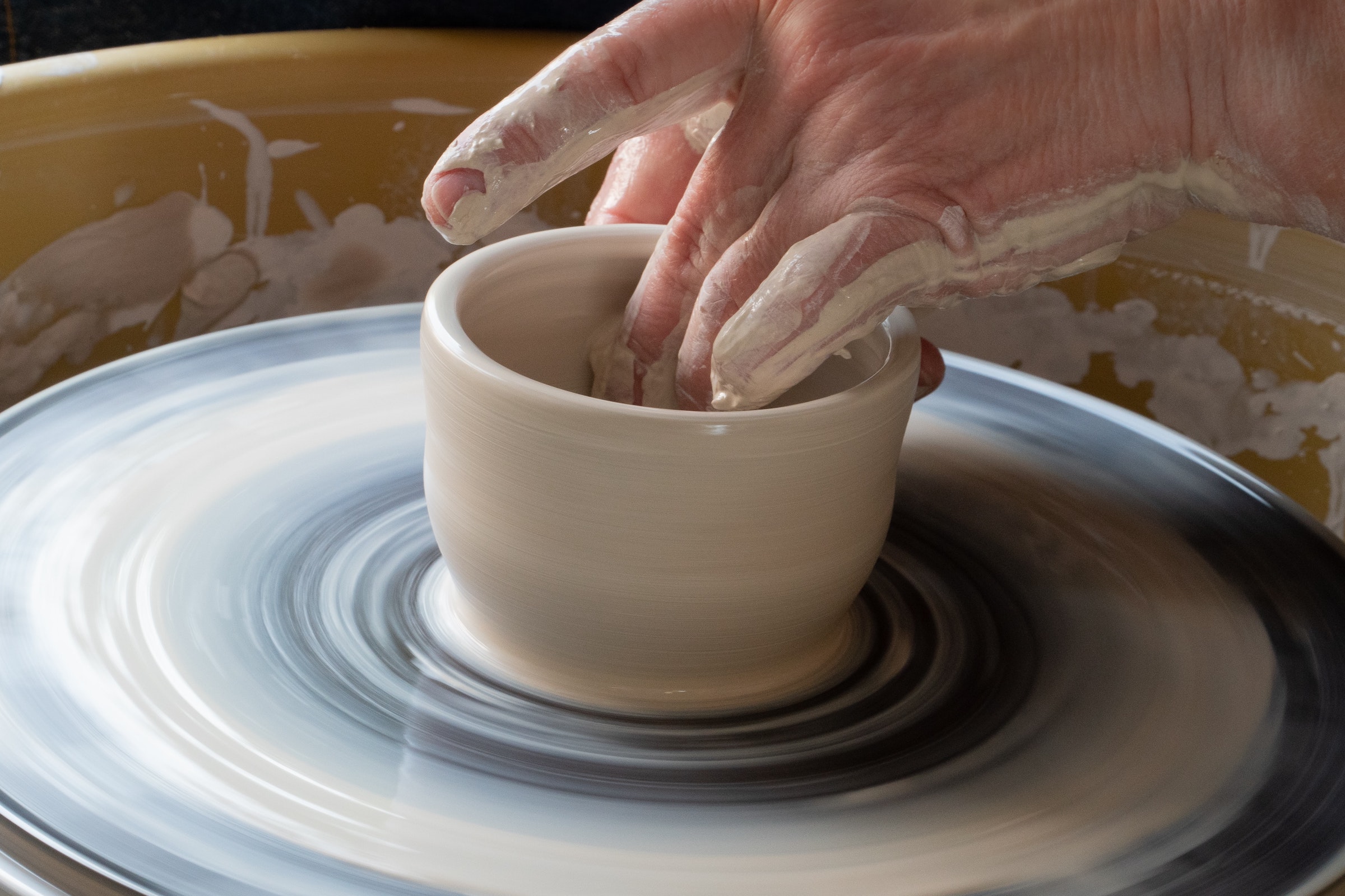 A bowl being made on a pottery wheel. 